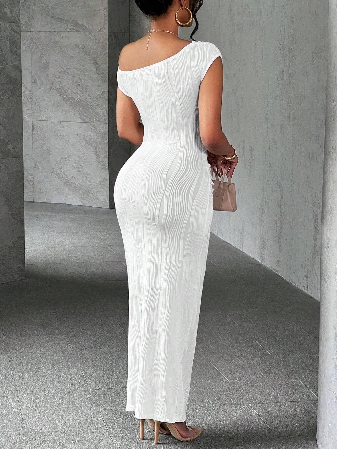 Back view of a white asymmetrical one shoulder ribbed bodycon maxi dress