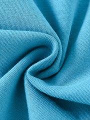 Close-up of soft folded cerulean knit fabric texture of children's short sleeve t-shirt