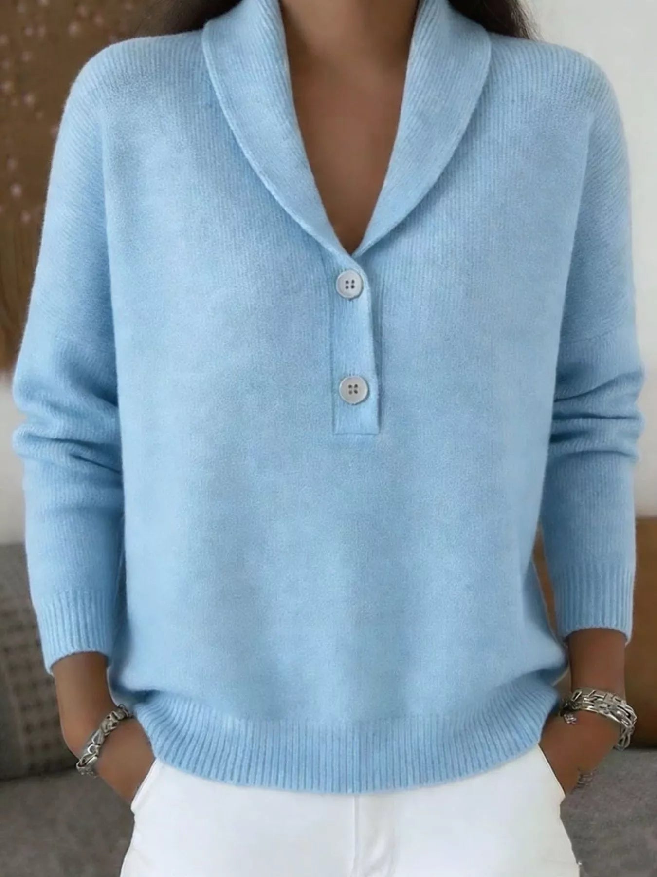 On-model front view of a light blue shawl collar sweater with white buttons