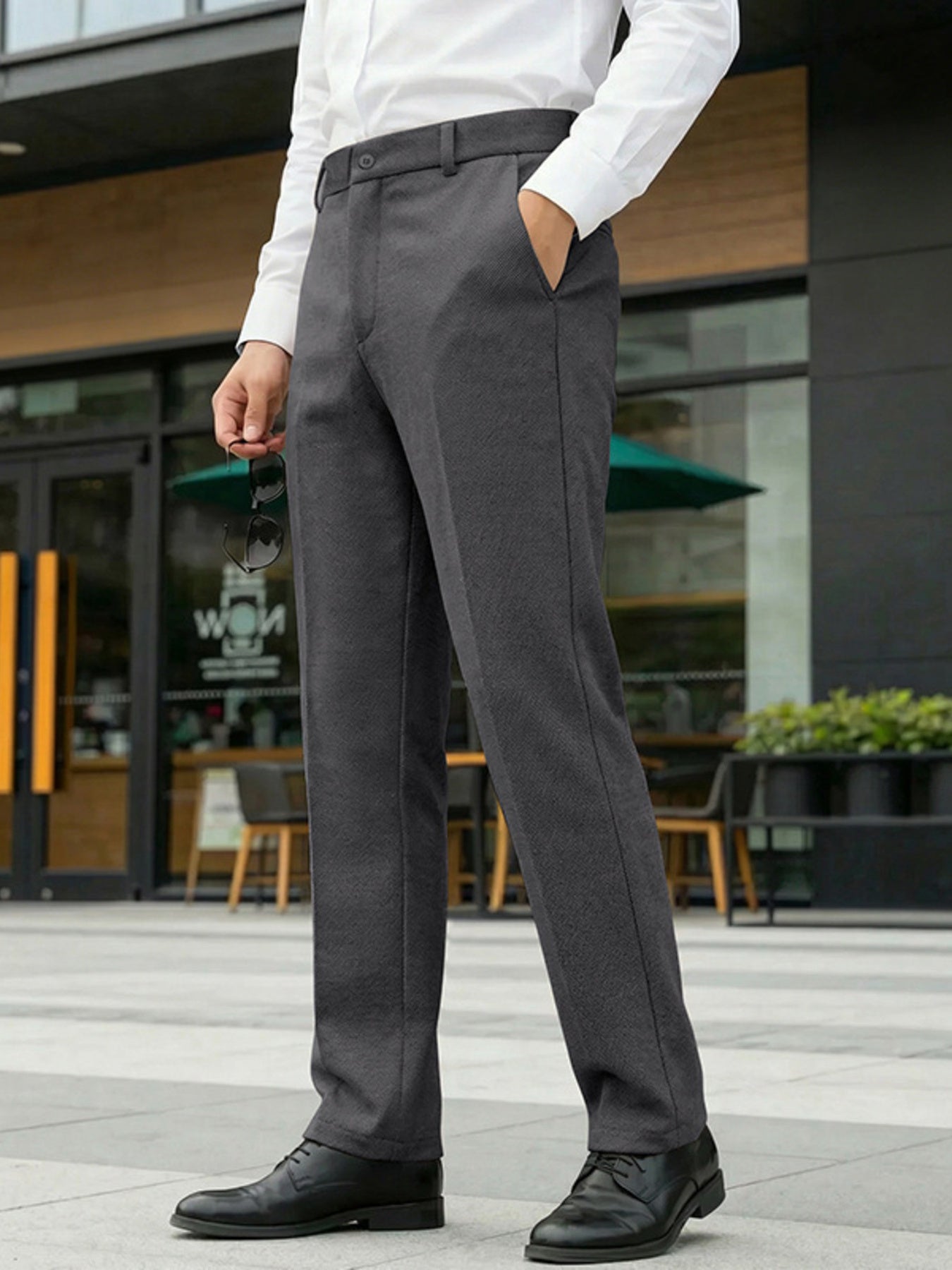 Men's dark gray dress pants with a classic fit and pockets.