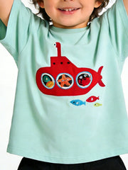 Close view of a mint children's tee with a red embroidered submarine and sea creatures in its round windows