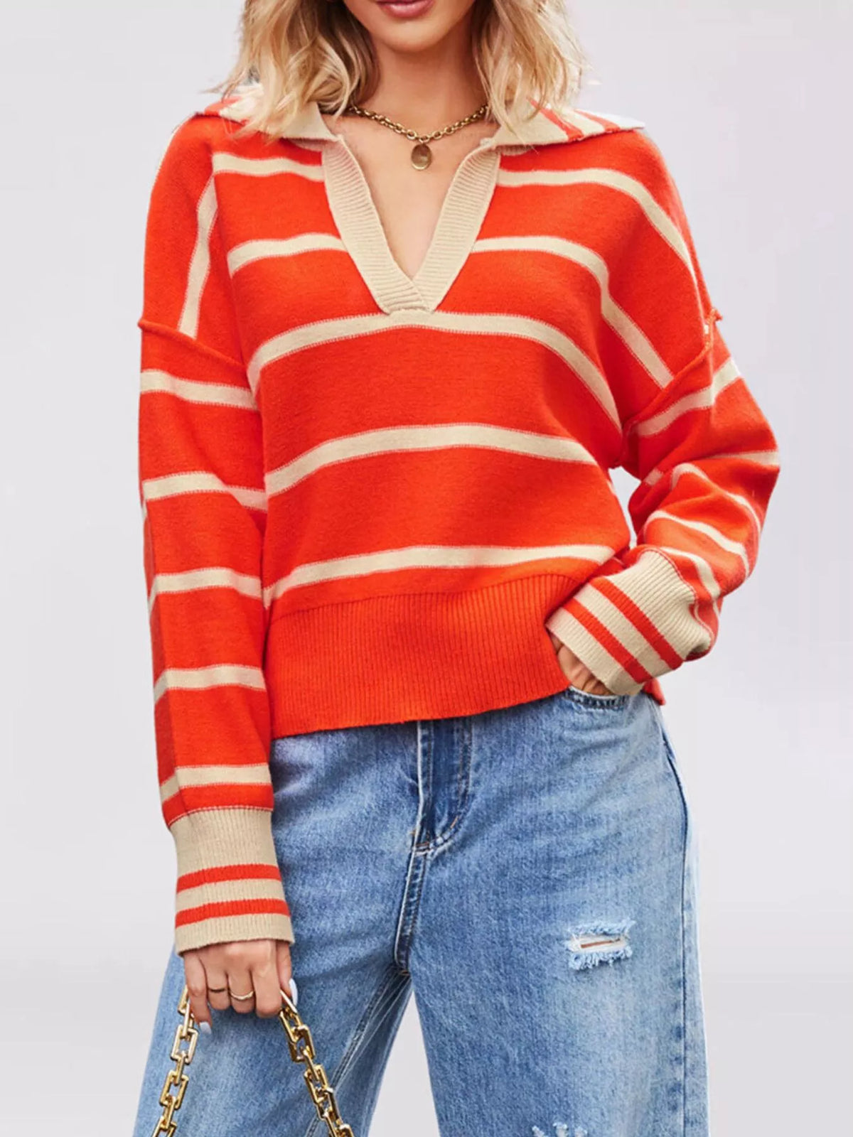 On-model front view of orange red striped sweater with beige Johnny collar and dropped shoulders