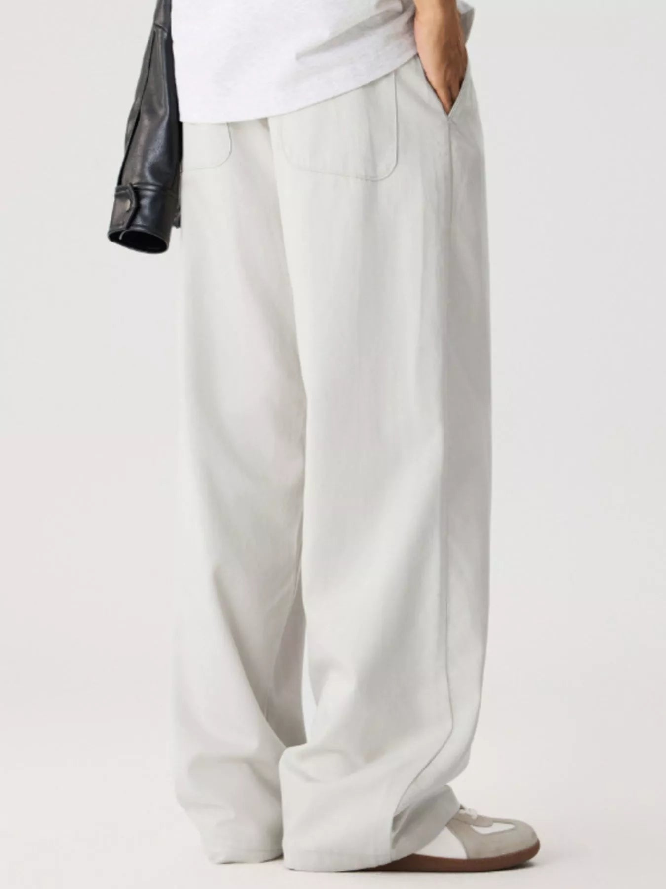 Men's relaxed fit pants with a drawstring waist and pockets.