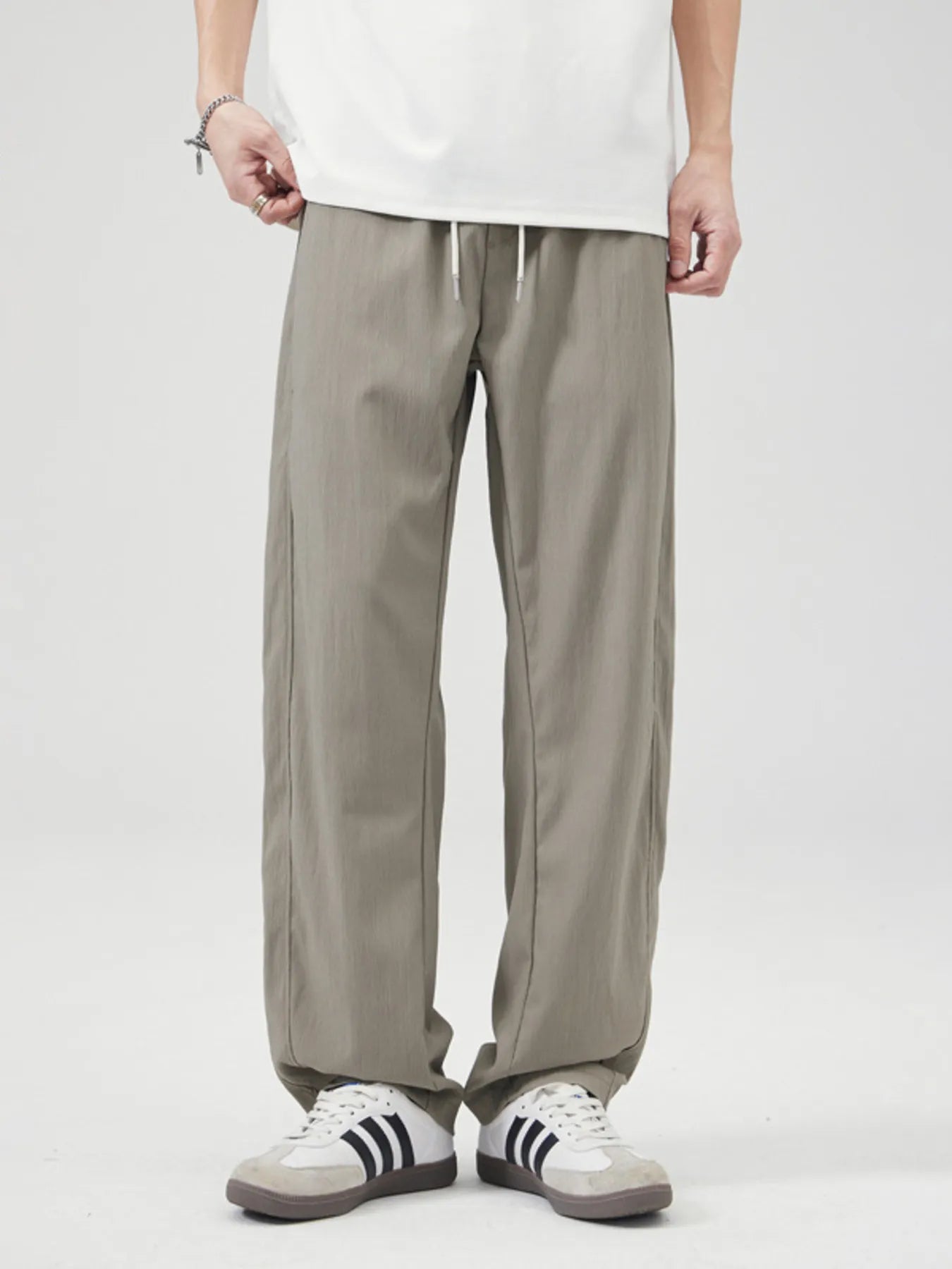 Men's gray green casual wide leg pants with a drawstring waist.