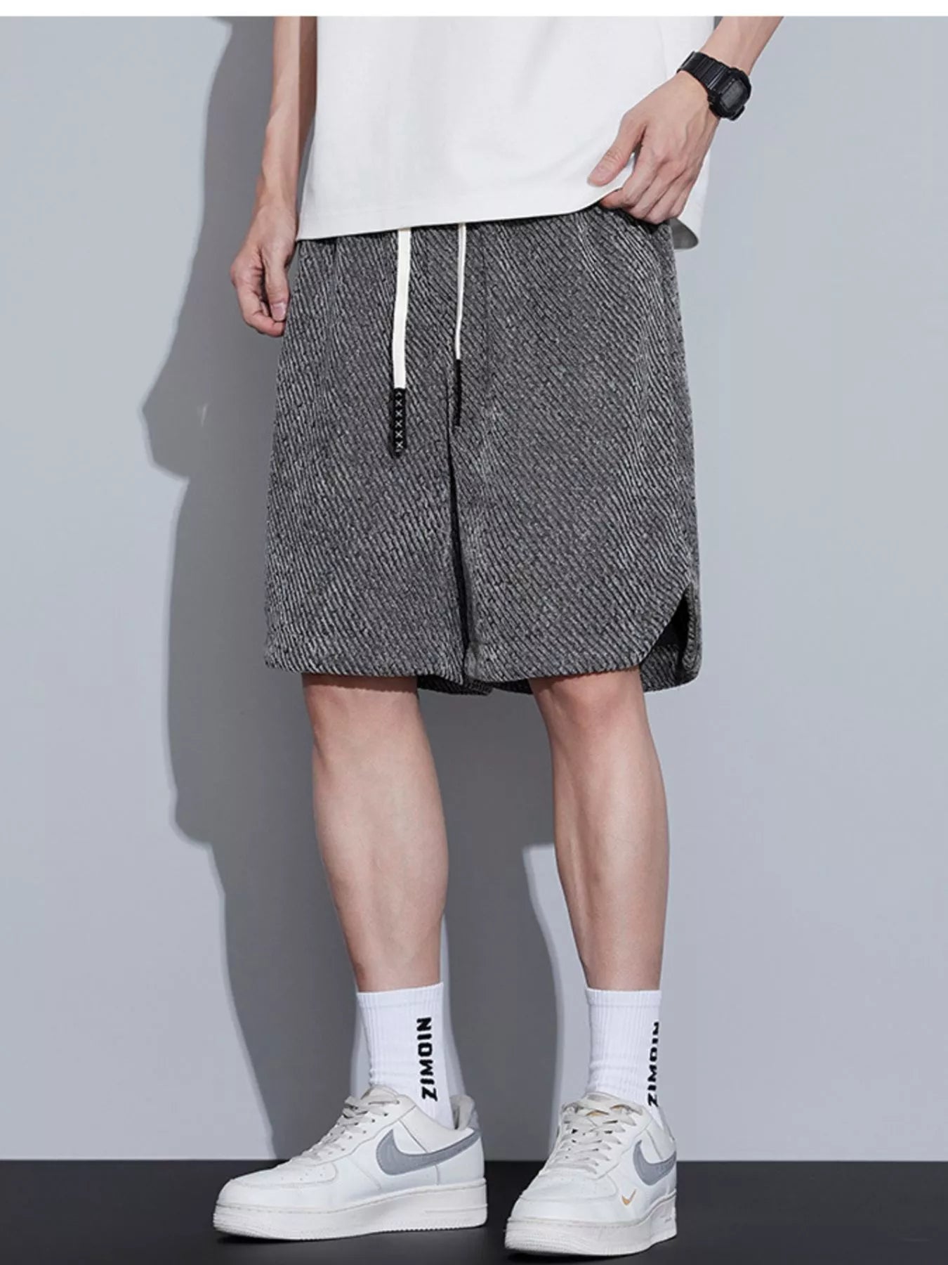 Men's loose fit shorts with a drawstring waist and pockets.