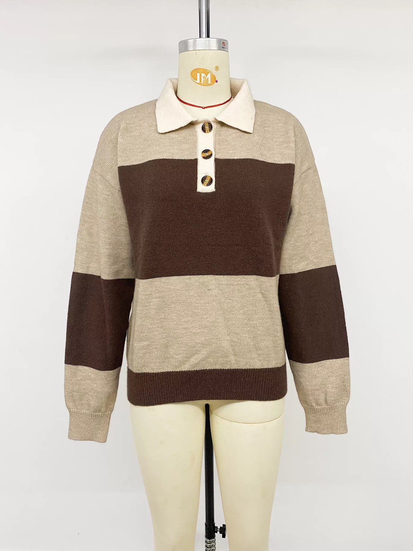 Front view of beige and brown color block polo sweater on a mannequin.