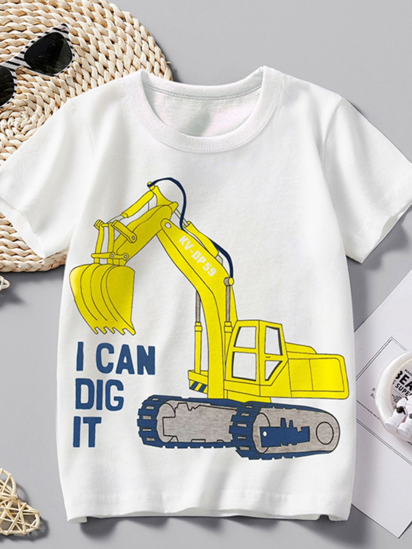 Flat lay front view of white children's tee with a large yellow excavator graphic