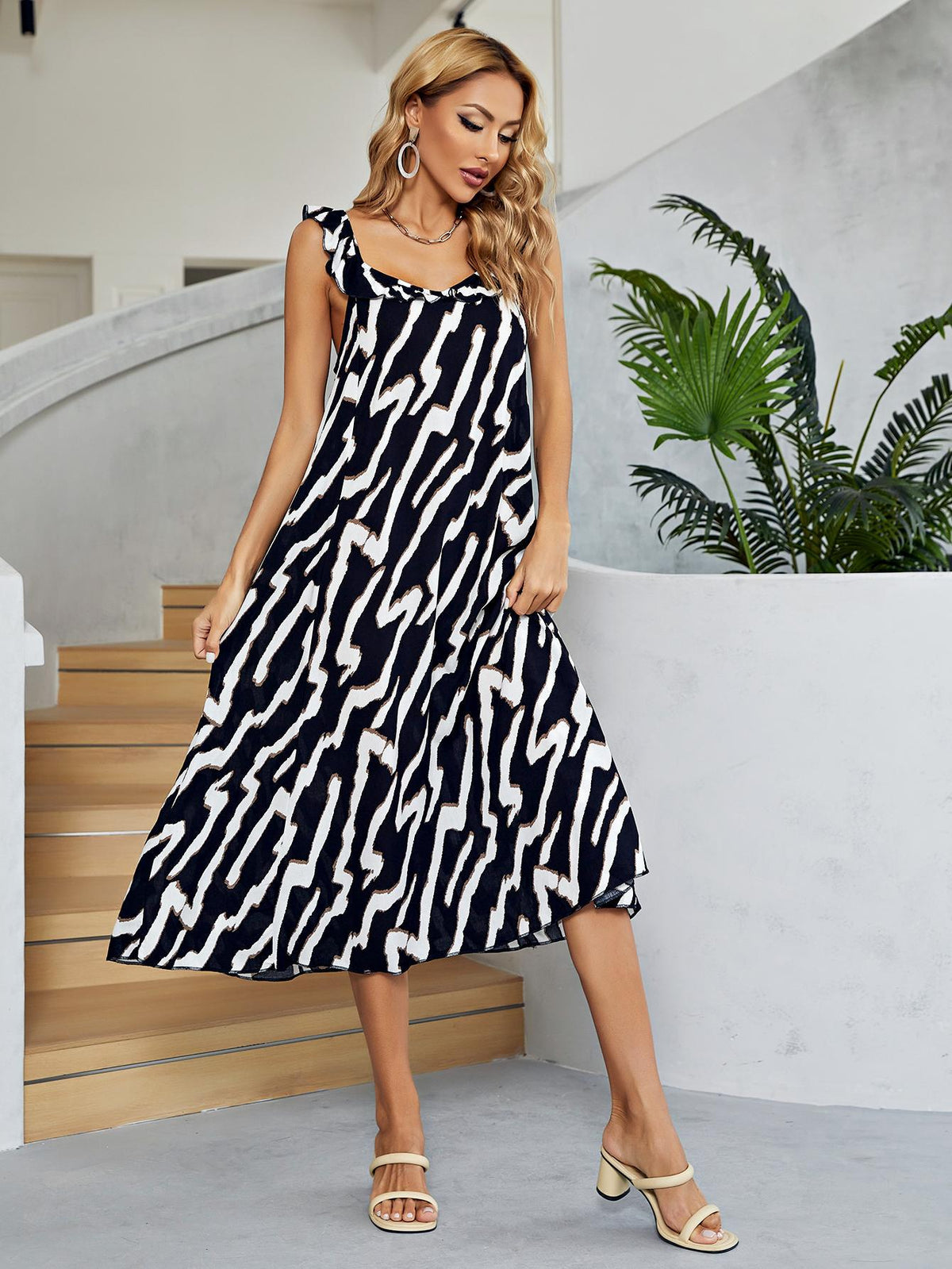 Women's black and white two-tone midi dress with a low back and V-neck.