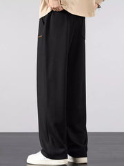 Men's loose fit casual pants with a drawstring waist and pockets.