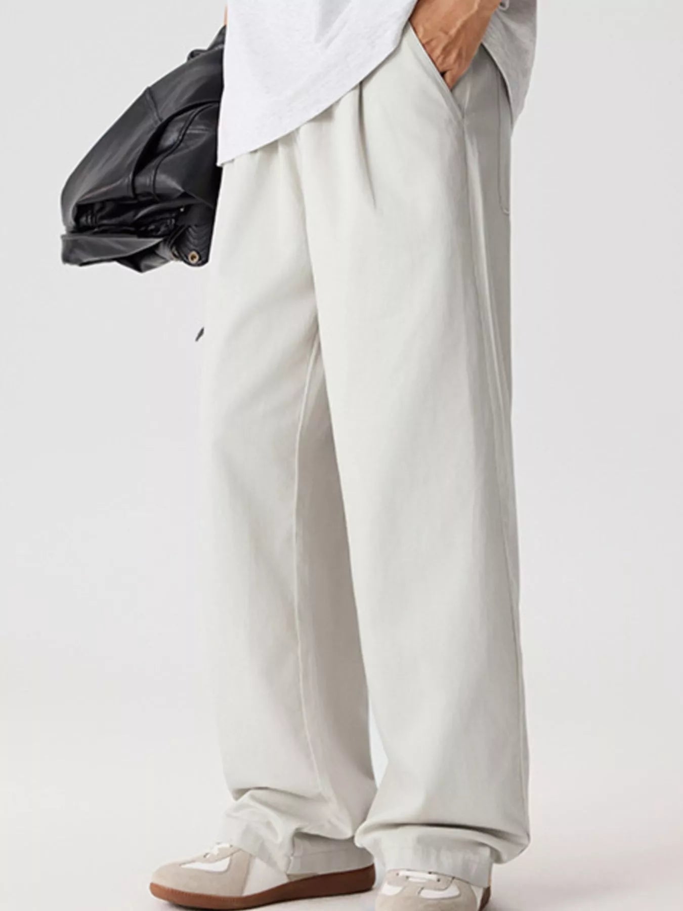 Men's relaxed fit pants with a drawstring waist and pockets.