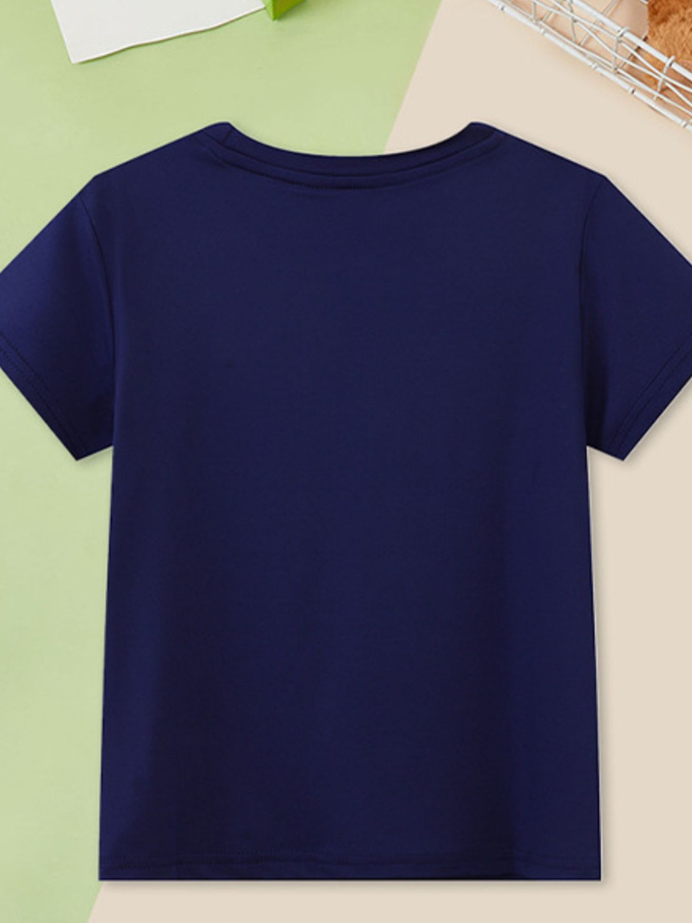 Back view of a plain navy children's short sleeve tee laid flat with a round neckline