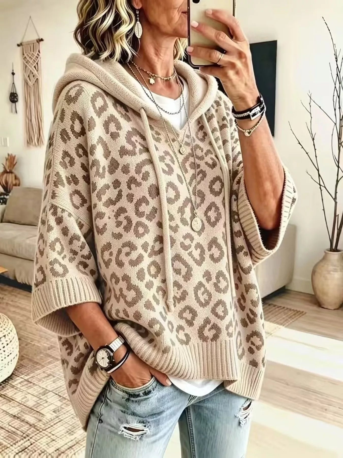 Cream leopard print oversized hooded knit sweater with taupe spots, front angle view