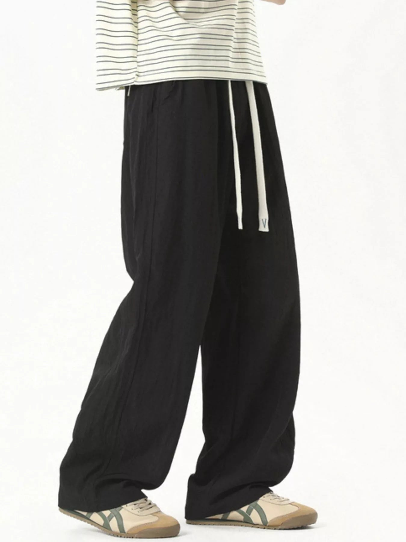 Men's lightweight loose fit casual pants with a drawstring waist.