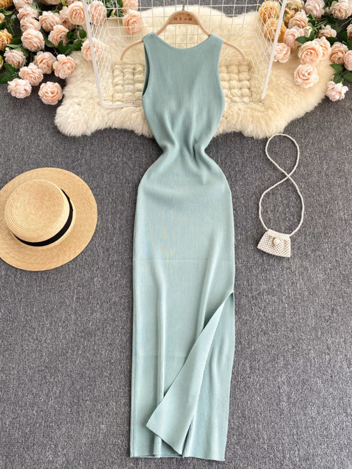 Mint sleeveless knit bodycon midi dress, front view with side slit on hanger