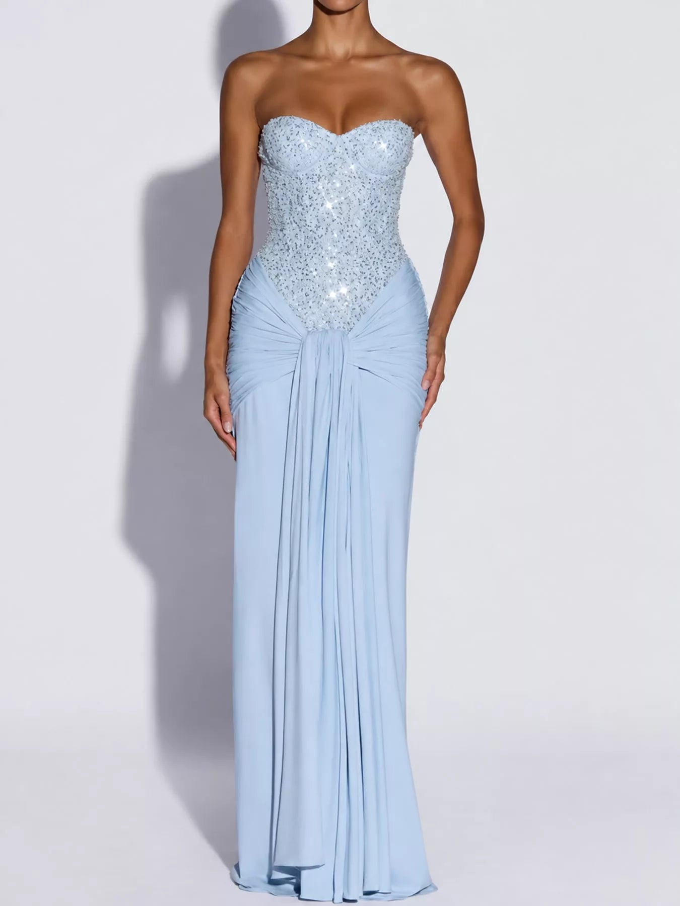 Blue strapless sequin corset maxi dress with draped waist on model, studio front view