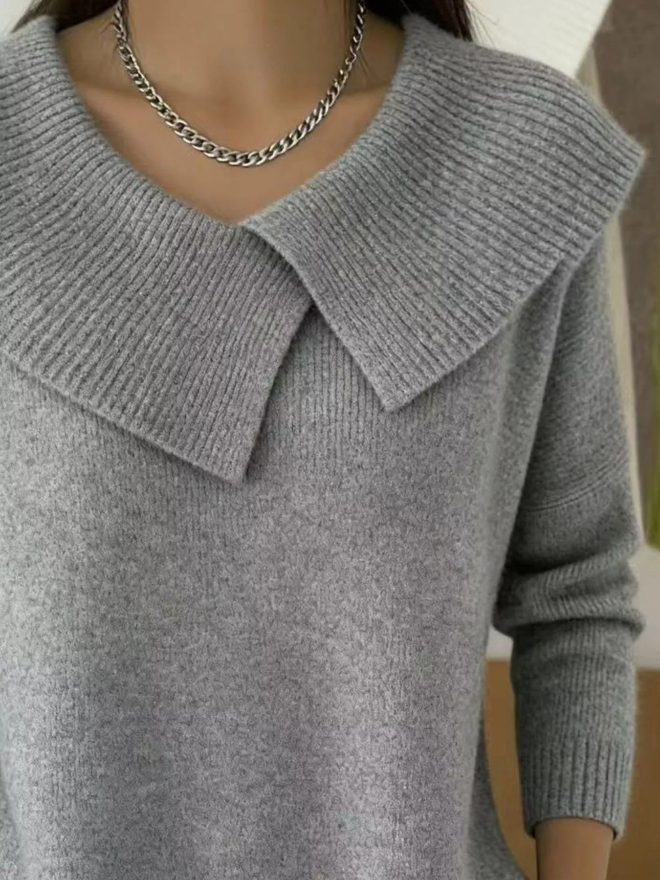 Close up of gray wide collar ribbed knit sweater showing overlapping collar and ribbing