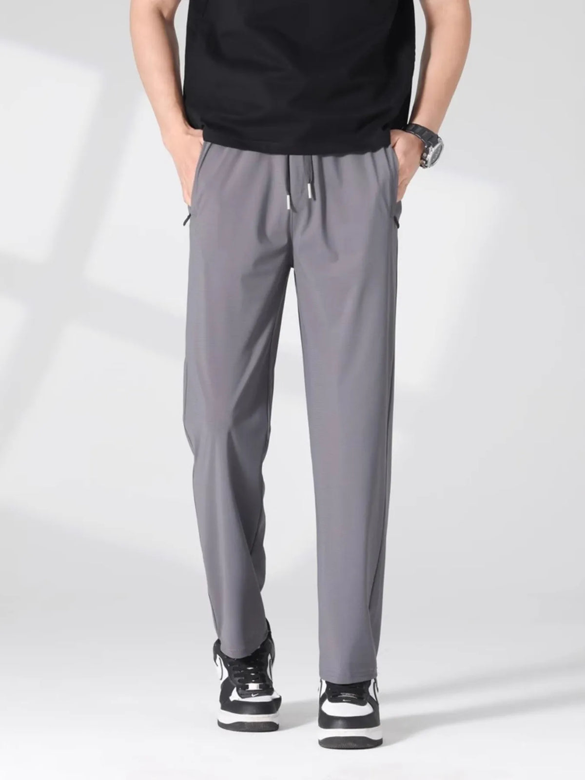 Men's light gray lightweight casual pants with a drawstring waist and pockets.