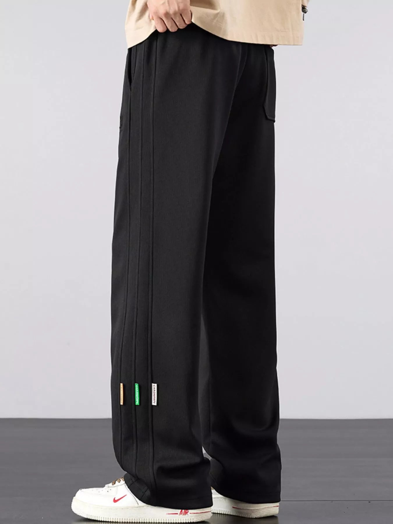 Men's casual loose fit pants with a drawstring waist and pockets.
