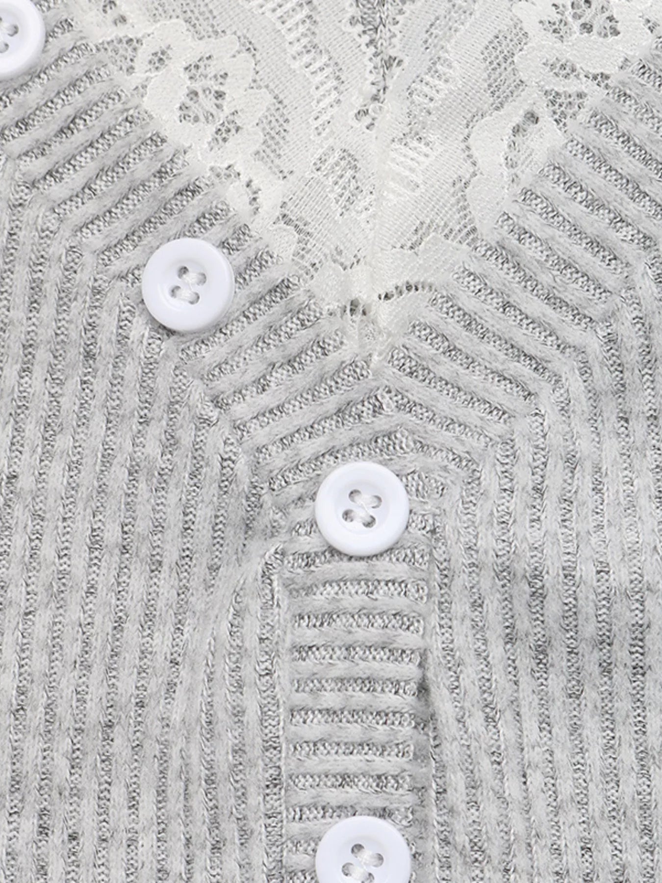 Close-up detail of a ribbed Henley neckline with lace trim and white buttons.