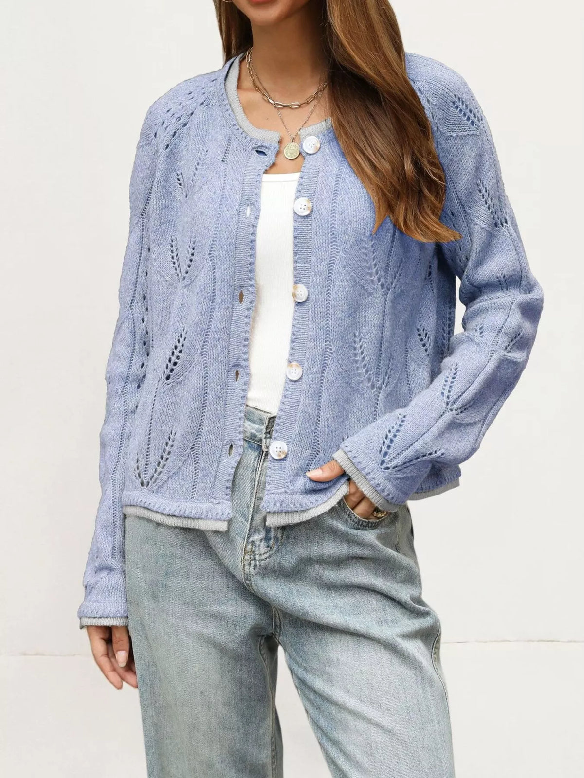 Light blue hollow out knit cardigan with leaf pattern worn open