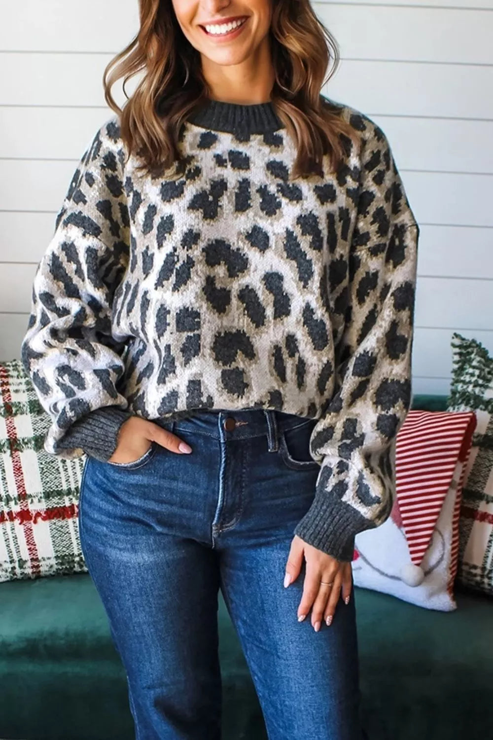 Front view of the gray and black leopard print baggy sweater with ribbed collar, indoors.