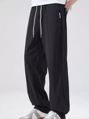 Men's black casual wide leg pants with a drawstring waist.
