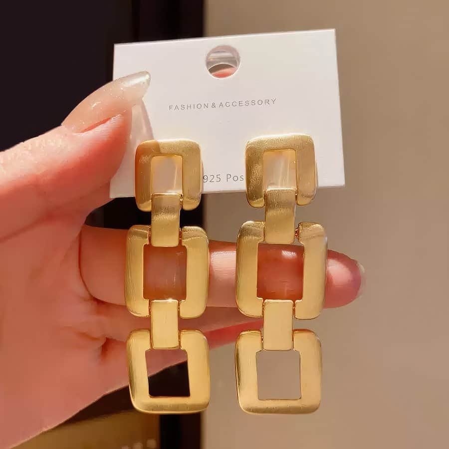 Contemporary Gold Tone Drop Earrings with Interlocking Geometric Links Gold