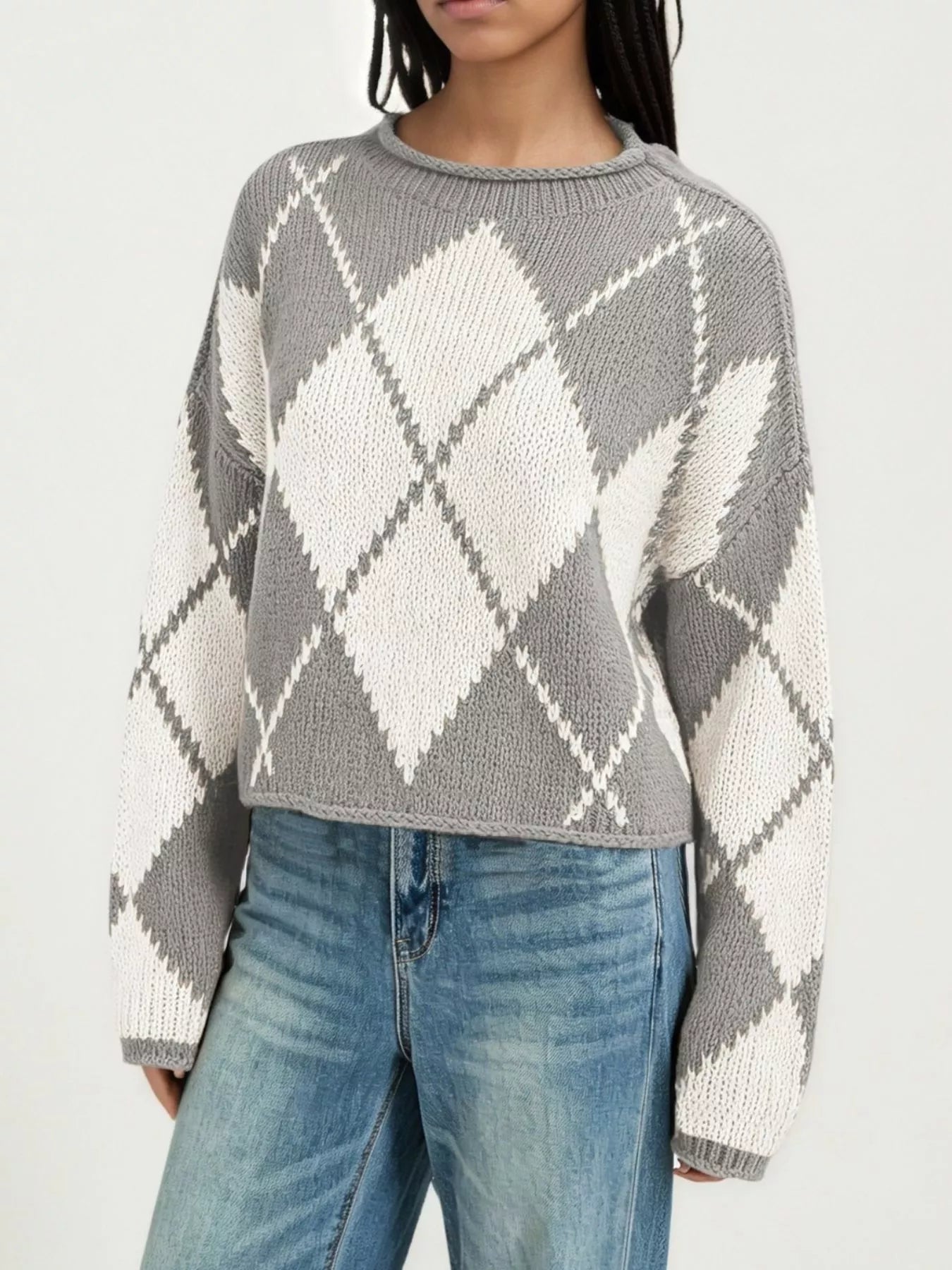 On-model front view of a gray and cream argyle knit sweater with dropped shoulders