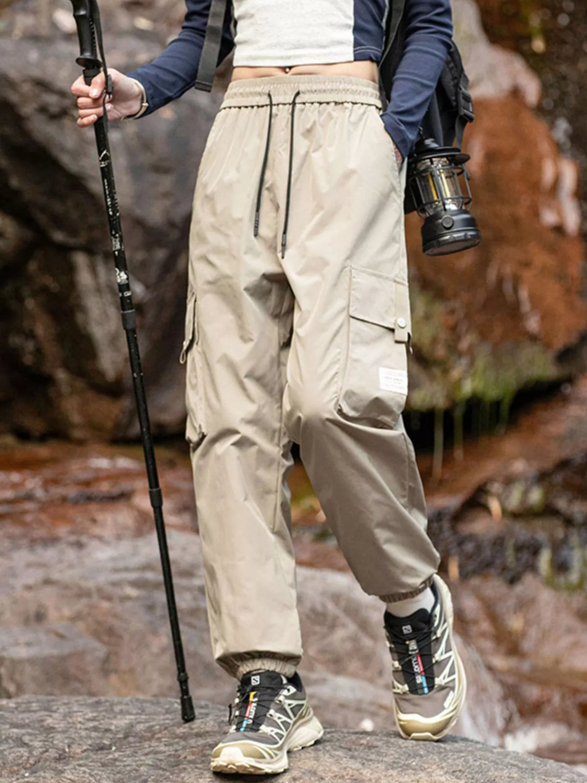 Men's beige loose-fit cargo pants with a drawstring waist and pockets.
