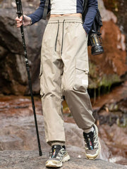 Men's beige loose-fit cargo pants with a drawstring waist and pockets.