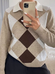 Mirror selfie front view of the argyle polo sweater showing the button placket and collar