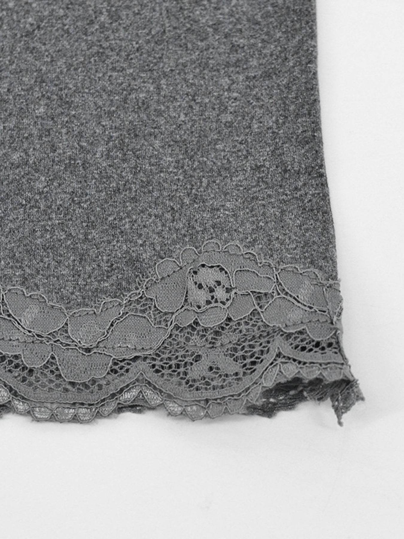 Close view of grey lace trim at the hem of the bodycon mini dress