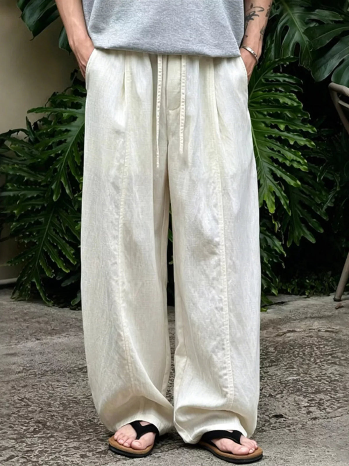 Men's wide-leg pants with a drawstring waist and pockets in the Flax color.