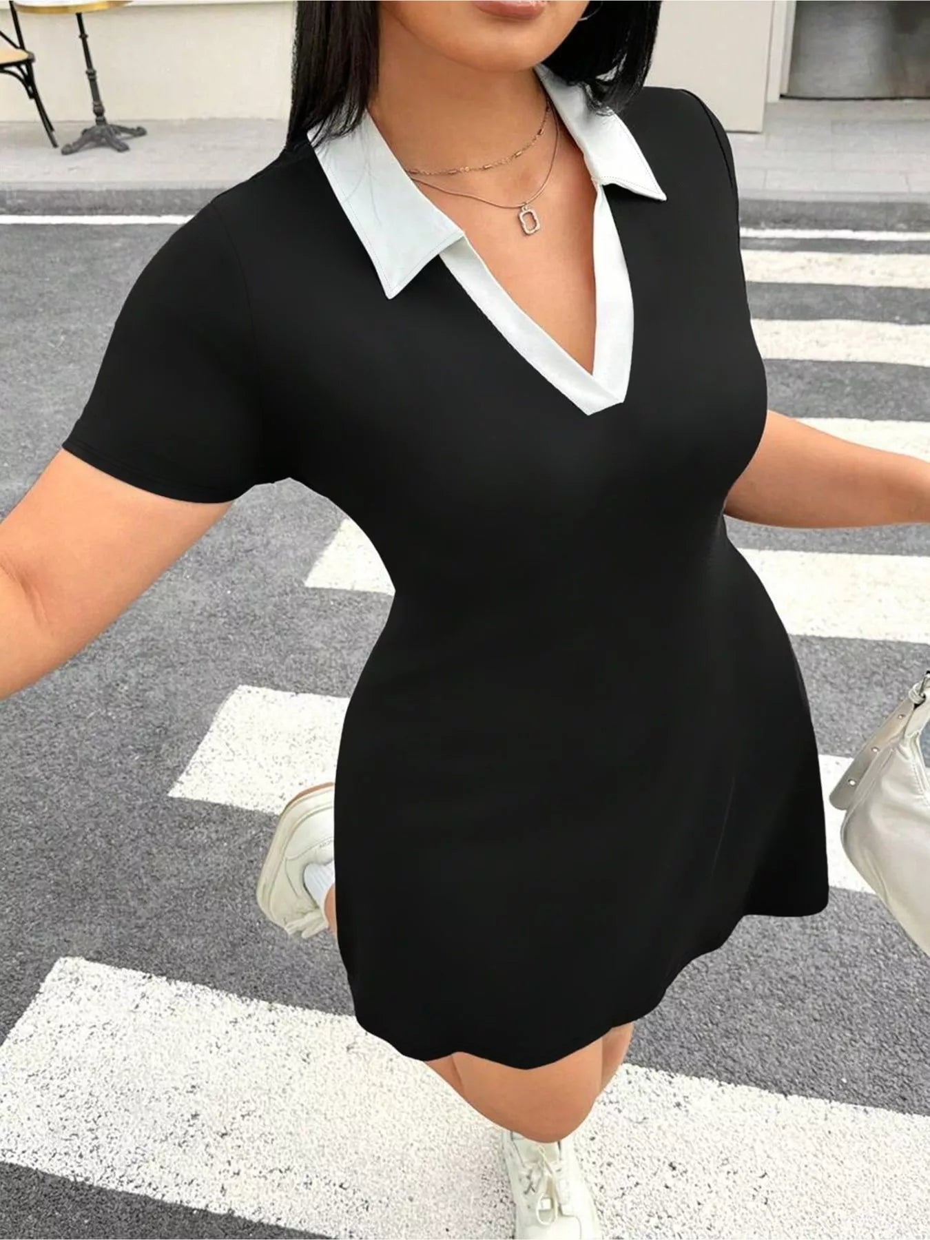 Close front view of black plus size mini dress with white contrast collar
