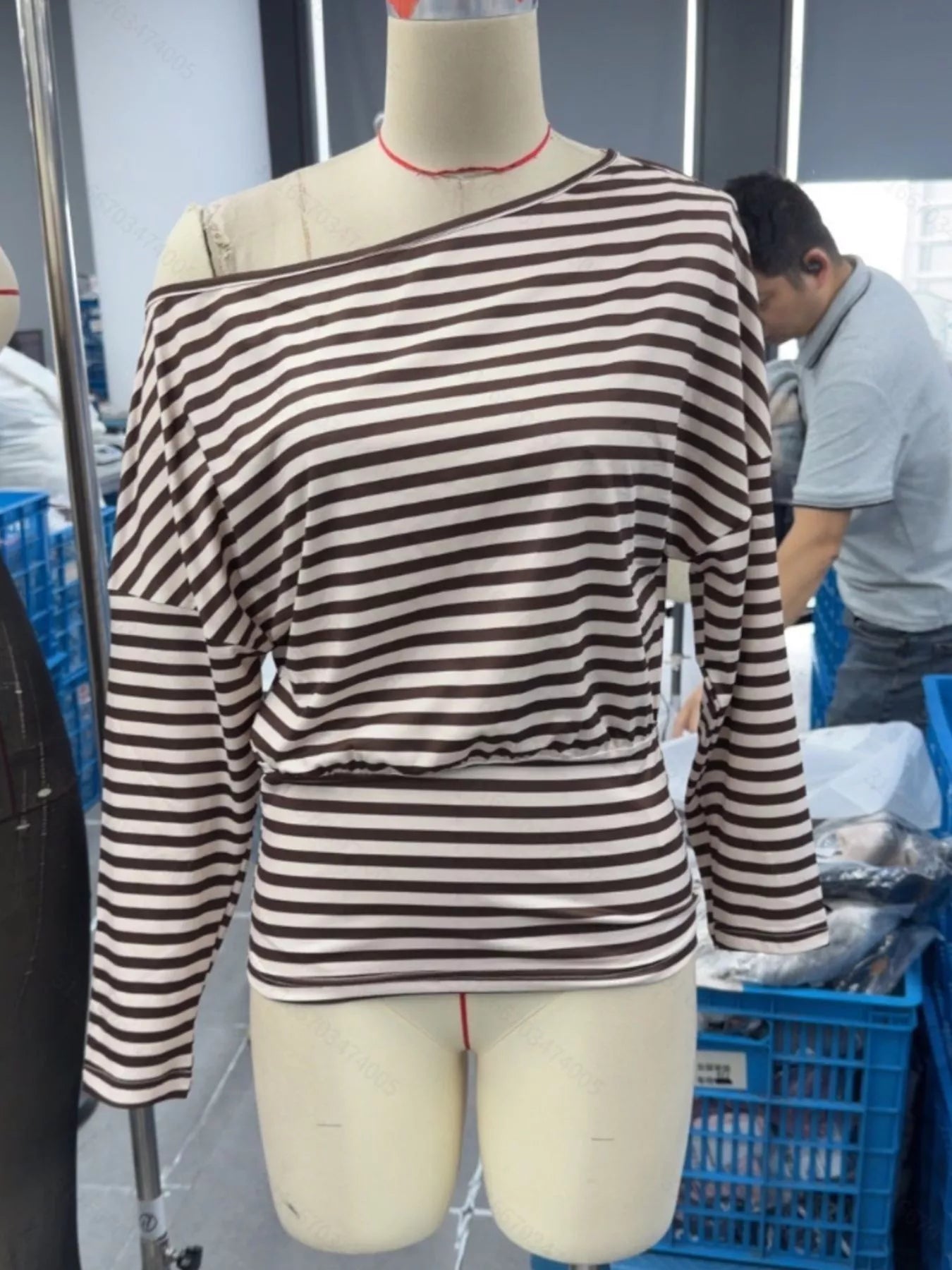 Front view of coffee brown and cream striped one shoulder long sleeve top on mannequin indoors