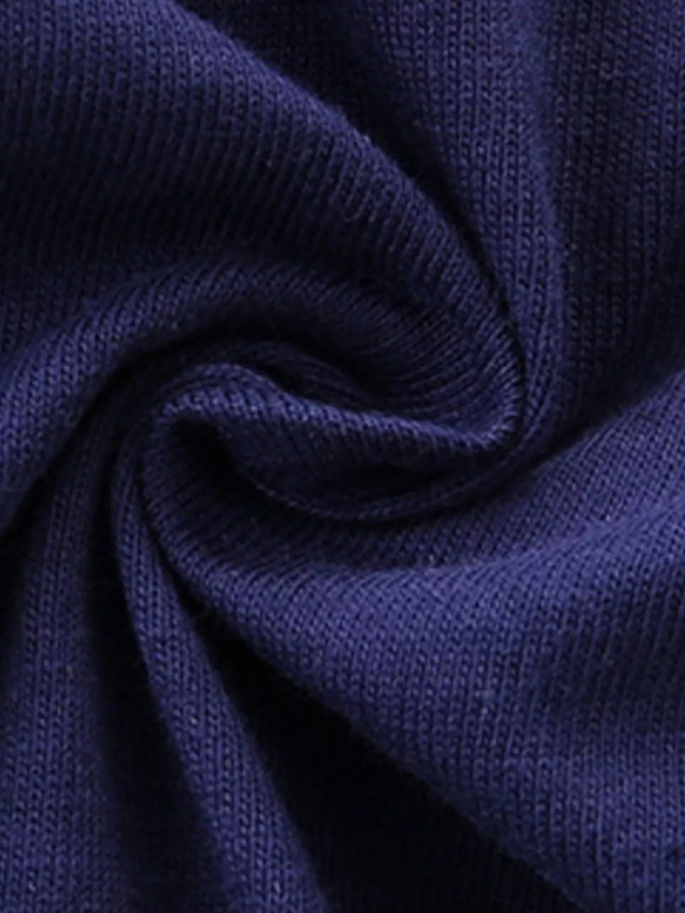 Close-up of the soft dark navy knit fabric showing its texture and drape