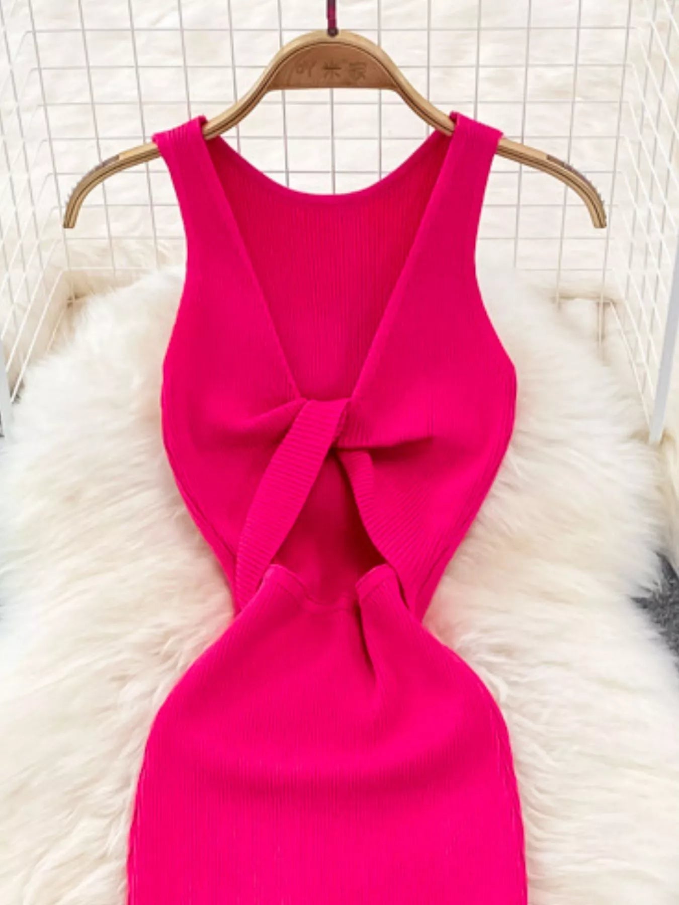 Close back view of rose red ribbed knit dress showing knotted open back detail