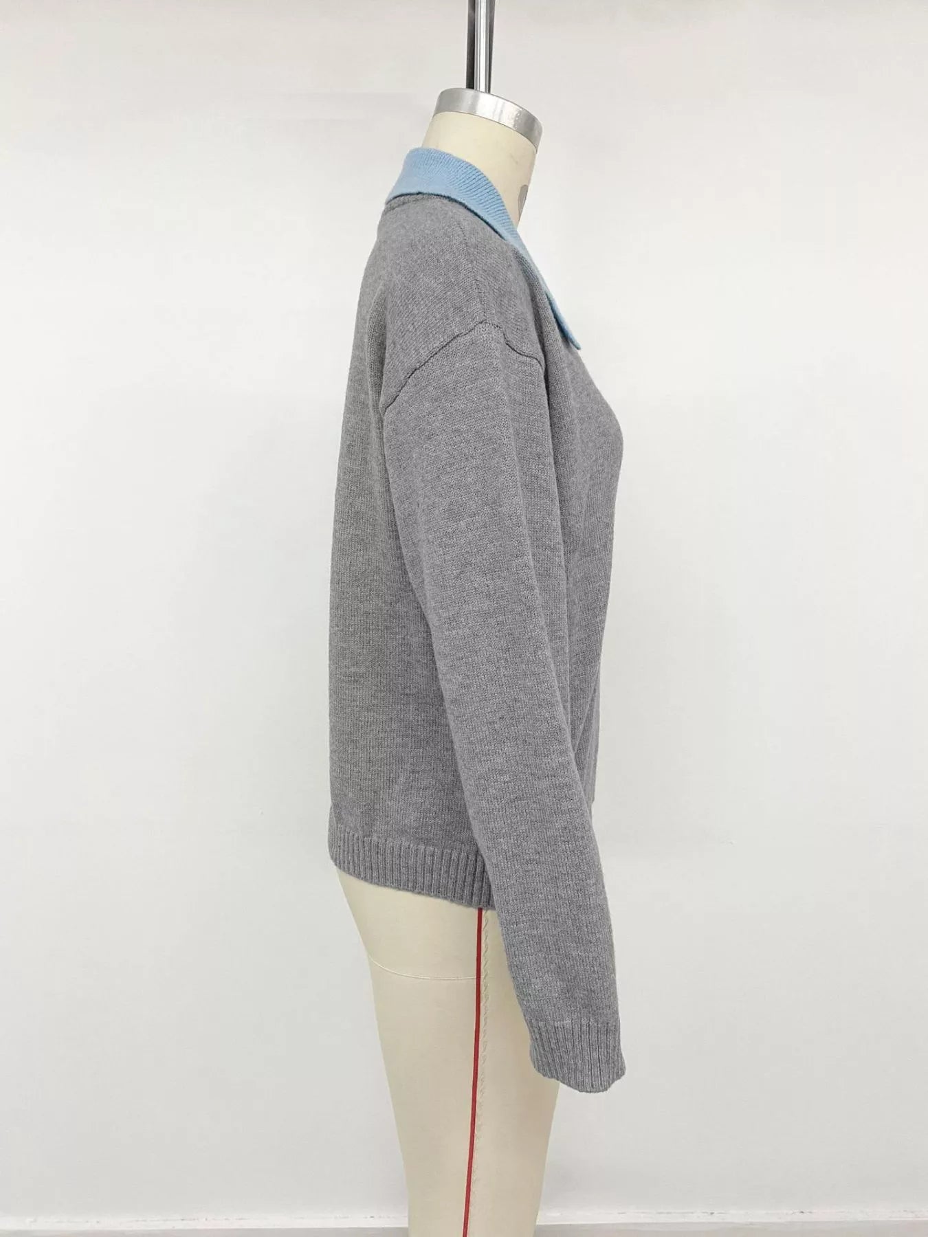 Side view of the gray contrast collar sweater displayed on a dress form