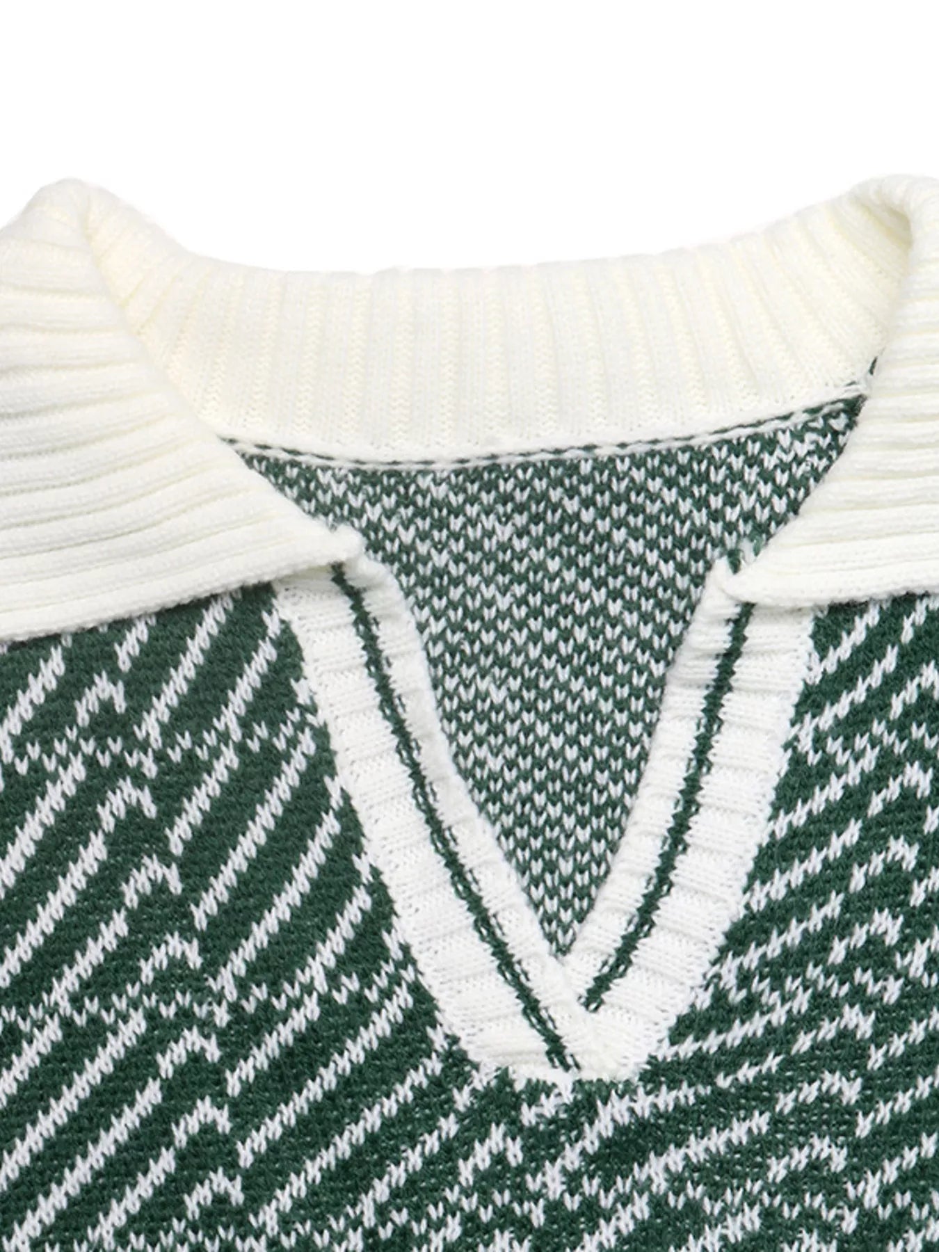 Close-up of the white ribbed collar and V neck on the green geometric sweater