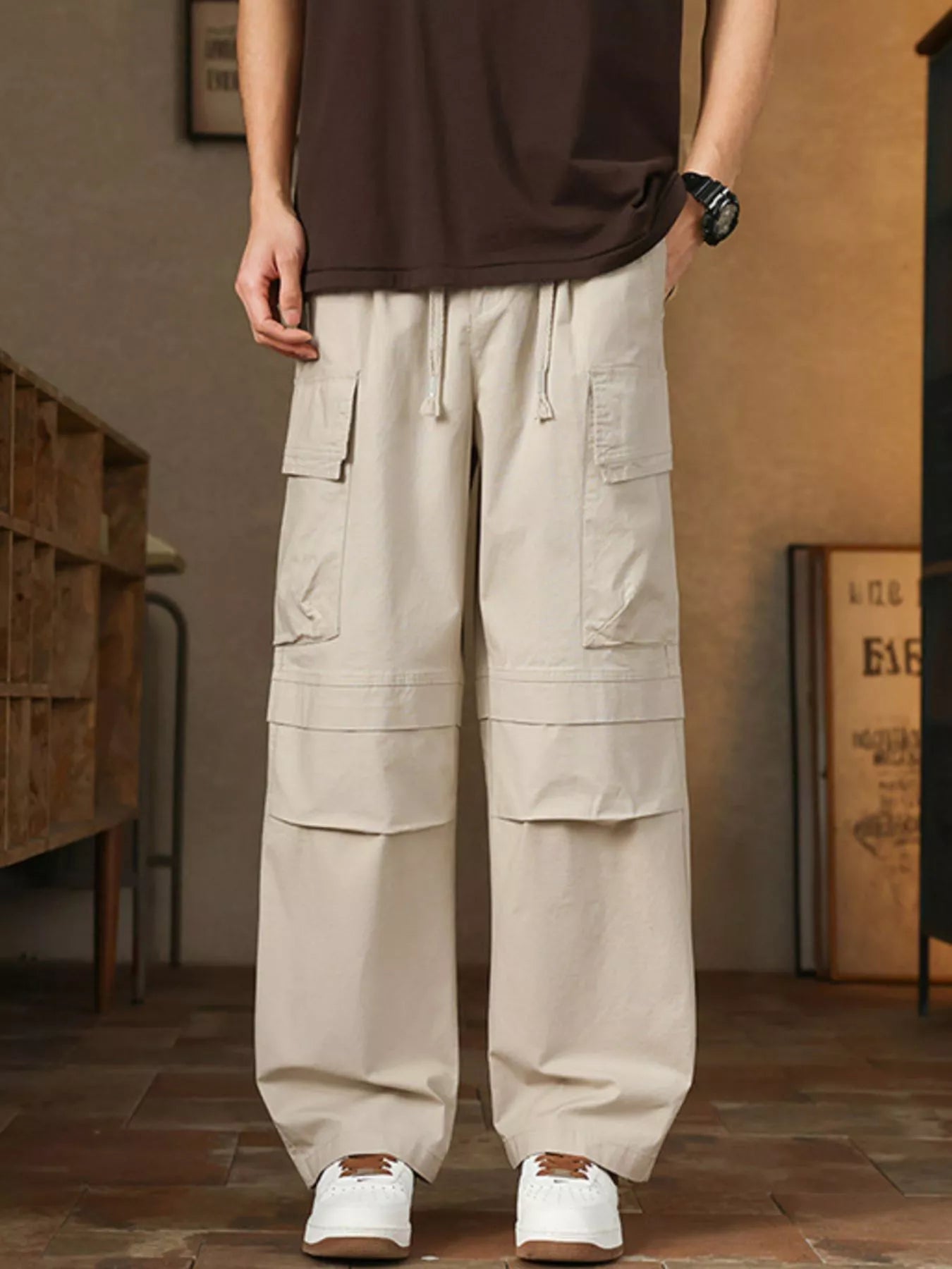 Men's relaxed fit cargo pants with a drawstring waist and pockets.