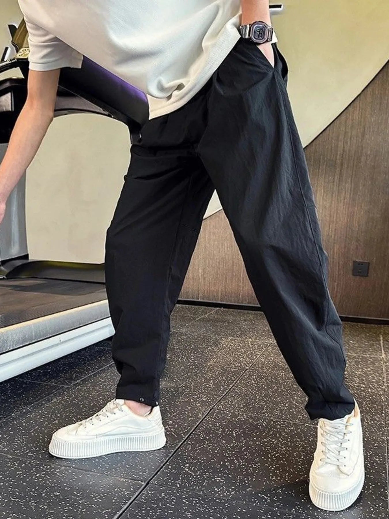 Men's black cotton-blend cargo pants with a drawstring waist and pockets.