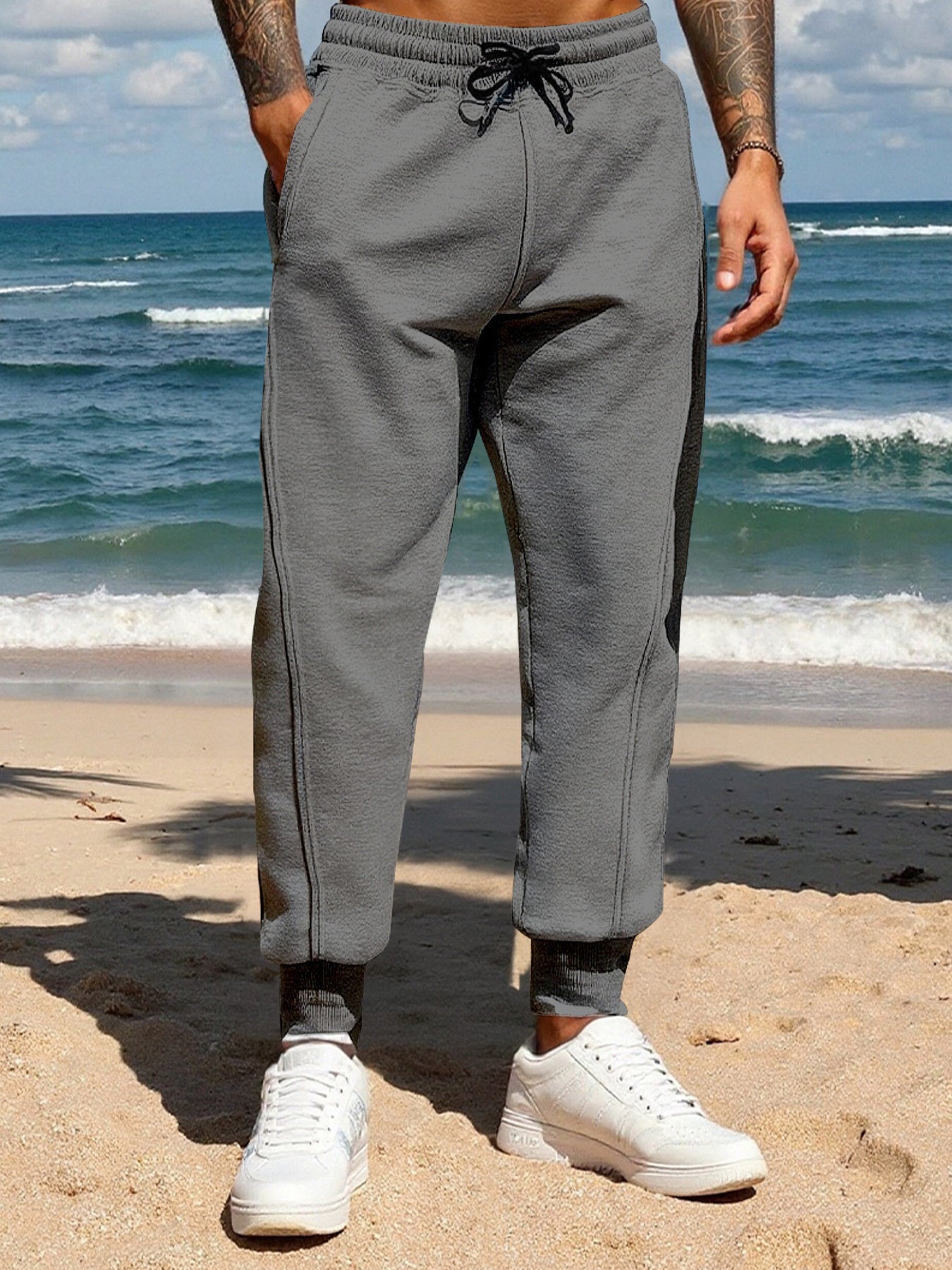 Men's dark gray casual joggers with a drawstring waist and pockets.
