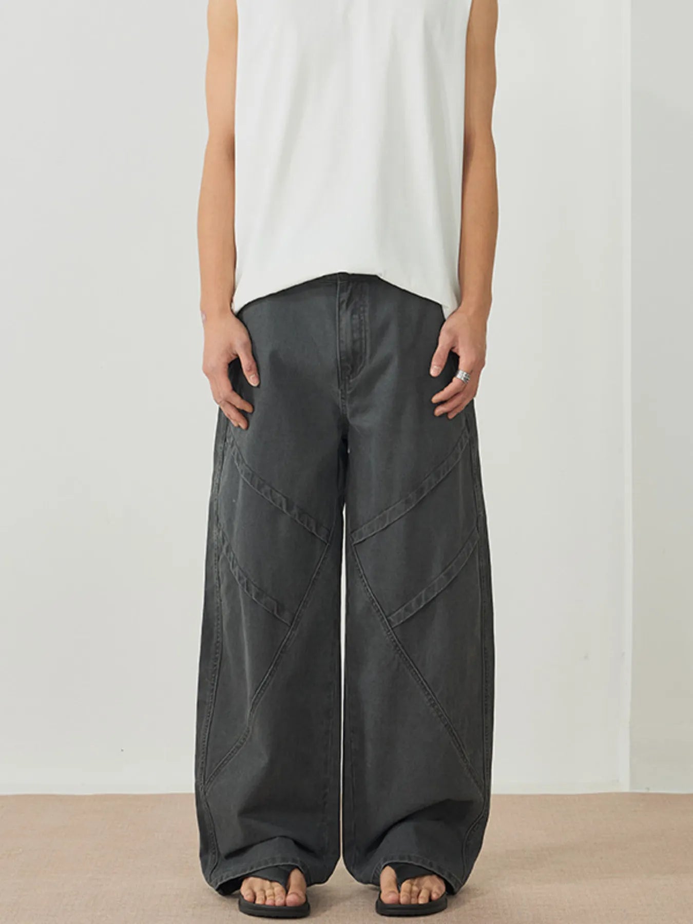 Men's dark gray wide-leg pants with an oversized fit and pockets.