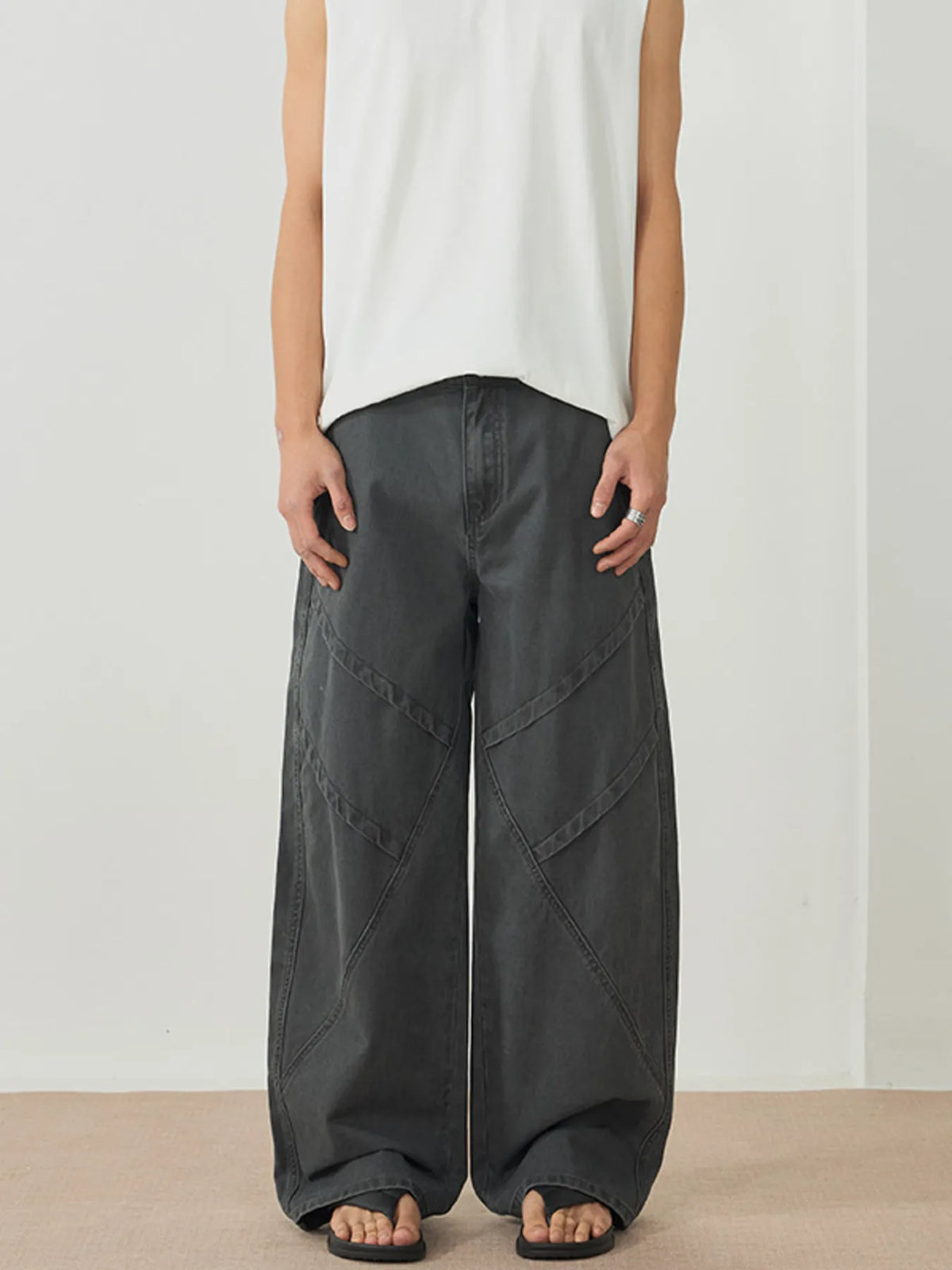 Men's dark gray wide-leg pants with an oversized fit and pockets.