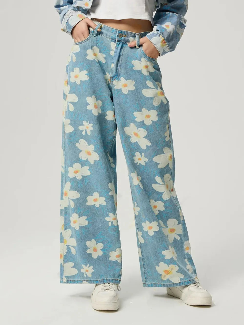 Women's floral wide-leg jeans with buttons and pockets.