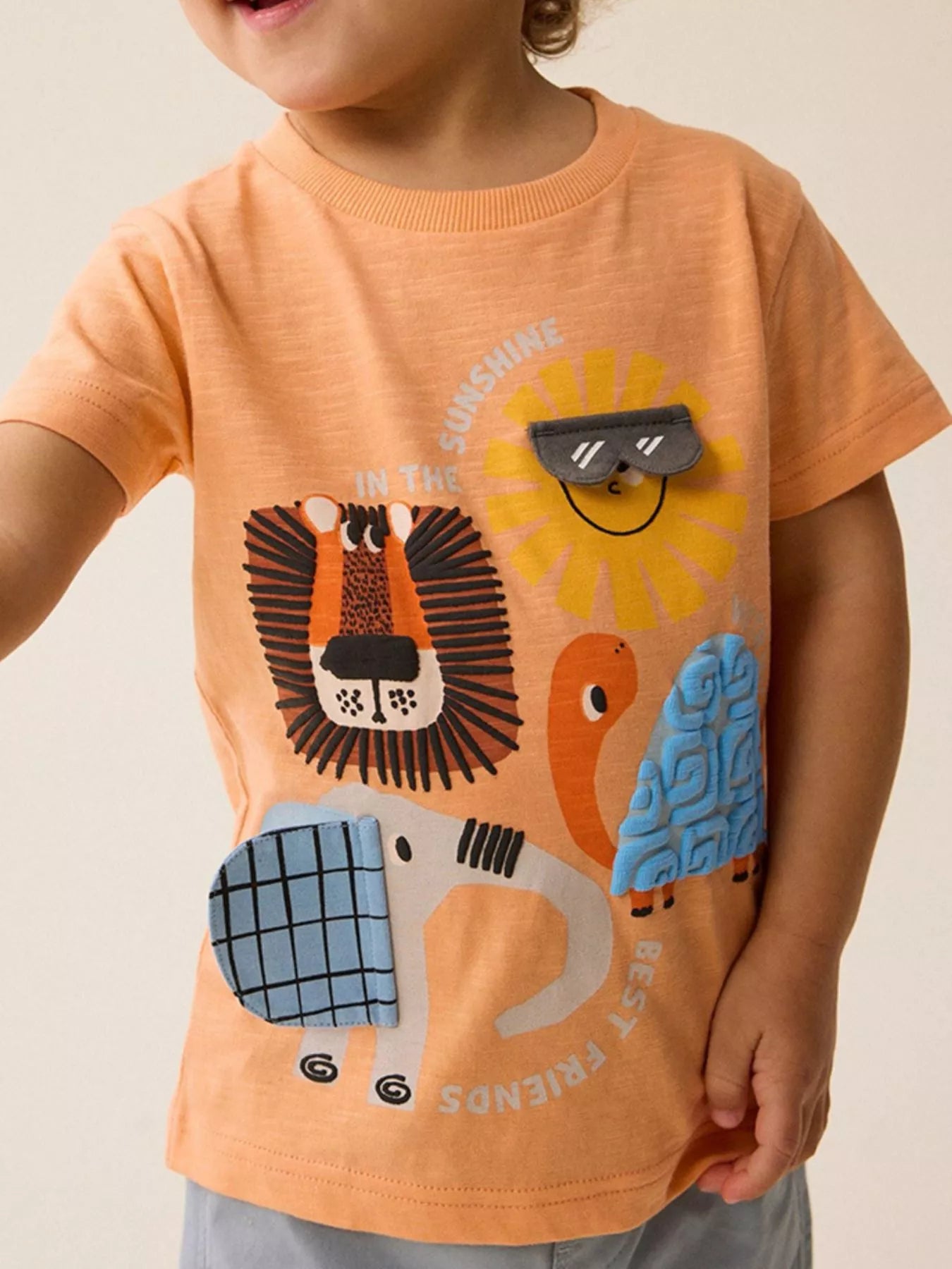 Children's tangerine cotton tee featuring the Sunshine and Friends graphic.