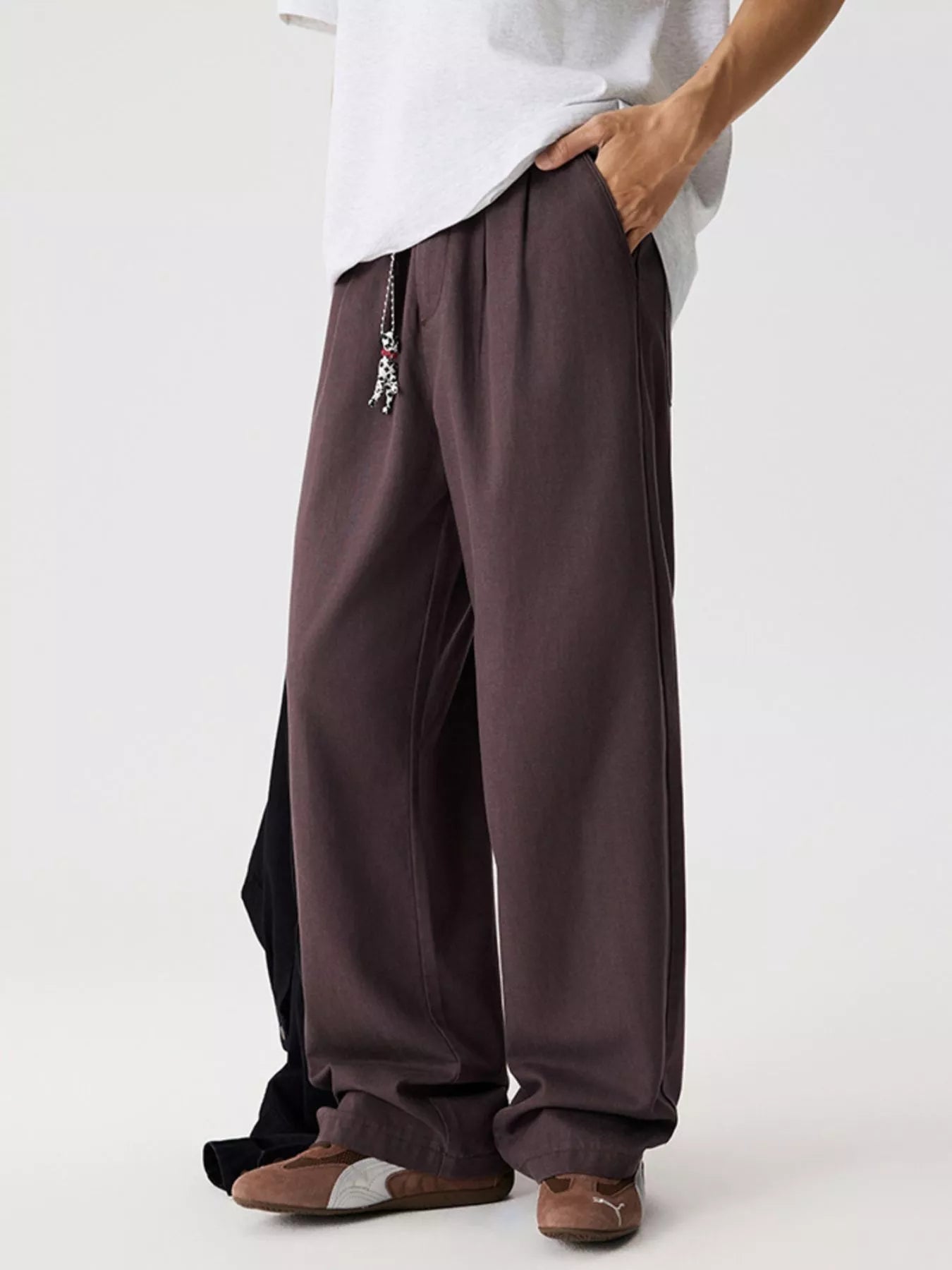 Men's relaxed fit pants with a drawstring waist and pockets.