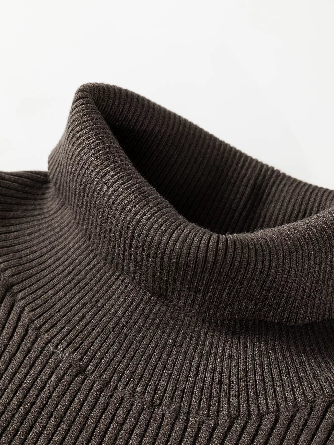 Close up of coffee brown ribbed high neck collar on sweater vest