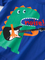 Close-up detail of green dinosaur playing guitar on royal blue children's t-shirt