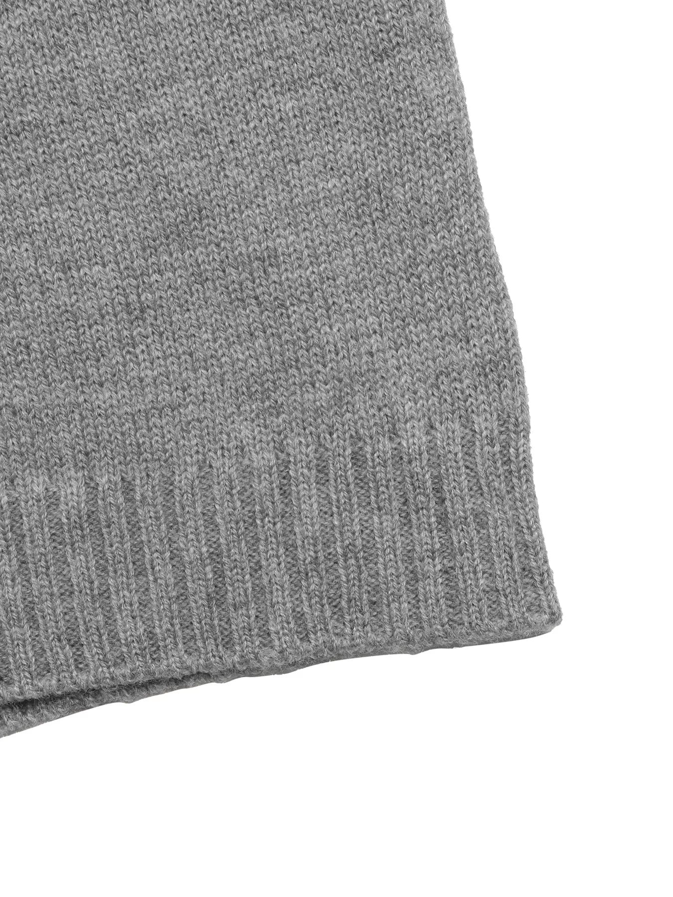 Close up of the gray ribbed hem and knit texture on the dropped shoulder sweater